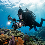 Underwater camera operator filming over a coral reef, illustrating ocean documentary production