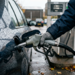 Driver refuelling a car in the rain, illustrating rising UK inflation driven by fuel prices