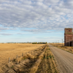 Autumn prairie fields with grain elevator and rural road, illustrating Alberta's independence referendum vote