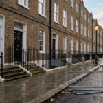 Quiet Georgian London terrace at dawn with crowd barriers, illustrating how a UK prime minister changes